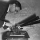 Circa 1897: A man operating an early Gramophone from the Gramophone & Typewriter Company.